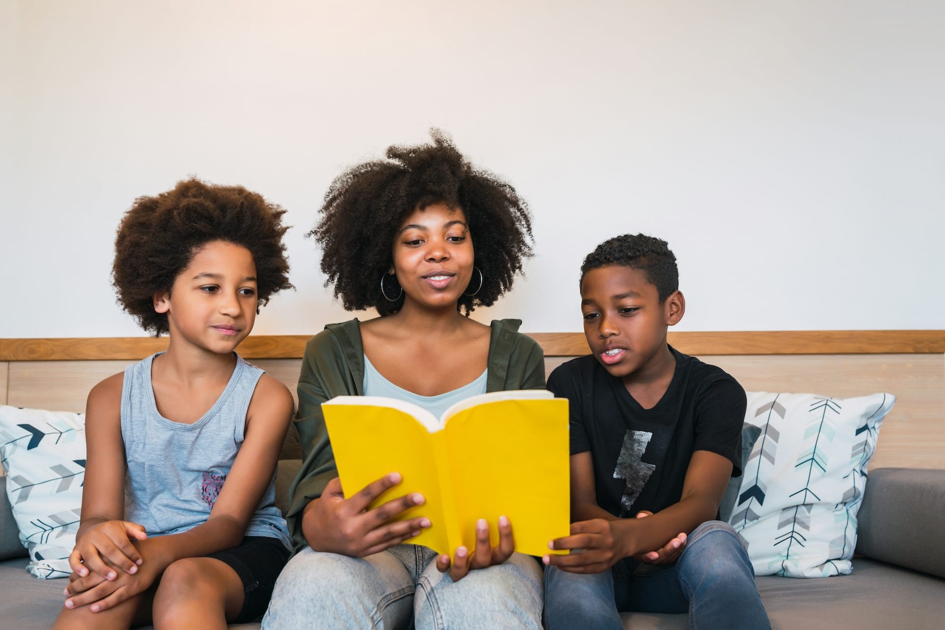 Mom Reading to Sons_small About All District Reads